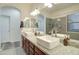 Bright bathroom features double sinks, granite counters, and walk-in shower with gray tile at 123 N Washington St # 16, Chandler, AZ 85225