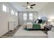 Cozy bedroom with modern ceiling fan, wood flooring, and natural light from multiple windows at 123 N Washington St # 16, Chandler, AZ 85225