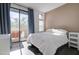 Bright bedroom with balcony access, an accent wall and a door to the exterior at 123 N Washington St # 16, Chandler, AZ 85225