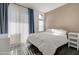Bright bedroom with sliding glass doors, hardwood floors, and comfortable white bedding at 123 N Washington St # 16, Chandler, AZ 85225