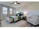Inviting bedroom with a ceiling fan, wood-look floors, a neutral color scheme and an accent chair at 123 N Washington St # 16, Chandler, AZ 85225