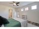 Bright bedroom features wood flooring, a ceiling fan, a door and a white dresser at 123 N Washington St # 16, Chandler, AZ 85225