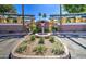 Inviting community feature with decorative fountain, lush landscaping, mature palms, and gated entry at 123 N Washington St # 16, Chandler, AZ 85225