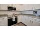 Modern kitchen featuring stainless steel appliances, granite countertops, and white cabinets providing ample storage space at 123 N Washington St # 16, Chandler, AZ 85225