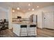 Well-lit kitchen showcasing a central island with barstool seating, modern stainless steel appliances, and ample cabinet space at 123 N Washington St # 16, Chandler, AZ 85225