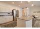 Bright, modern kitchen featuring stainless steel appliances, granite countertops, and a central island with seating near dining area at 123 N Washington St # 16, Chandler, AZ 85225