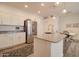 Modern kitchen featuring stainless steel appliances, granite countertops, and a central island with seating, seamlessly connecting to the dining area at 123 N Washington St # 16, Chandler, AZ 85225