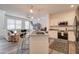 Open-concept living space with a comfortable sofa, large windows, and modern kitchen featuring stainless steel appliances at 123 N Washington St # 16, Chandler, AZ 85225