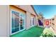 This backyard includes artificial turf, a wood fence, and doors to access the home's interior at 12445 N 21St Ave # 4, Phoenix, AZ 85029