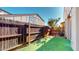 A cozy backyard features artificial grass, wood fencing, and a young tree adding charm and privacy at 12445 N 21St Ave # 4, Phoenix, AZ 85029