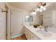 Bathroom featuring double sinks, quartz countertops, and brick textured walls at 12445 N 21St Ave # 4, Phoenix, AZ 85029