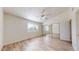 Bedroom featuring a ceiling fan, wood floors, a window, and a sliding mirror door closet at 12445 N 21St Ave # 4, Phoenix, AZ 85029