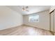 Bedroom with a ceiling fan, wood floors, and a window offering natural light at 12445 N 21St Ave # 4, Phoenix, AZ 85029