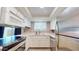 A well-lit kitchen featuring stainless steel appliances, white cabinetry, countertops, and tiled backsplash at 12445 N 21St Ave # 4, Phoenix, AZ 85029