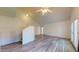 Spacious living room featuring high ceilings, wood-look floors, ceiling fan, and a staircase at 12445 N 21St Ave # 4, Phoenix, AZ 85029