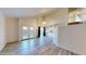 Bright living room featuring wood floors, a ceiling fan, and sliding glass doors at 12445 N 21St Ave # 4, Phoenix, AZ 85029