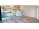 A bright living room featuring wood-look floors, high ceilings, white walls, open floor plan, and modern finishes at 12445 N 21St Ave # 4, Phoenix, AZ 85029