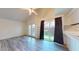 Spacious living room with wood-look floors, high ceilings, and a sliding glass door to the backyard at 12445 N 21St Ave # 4, Phoenix, AZ 85029