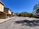 A quiet street showcases well-maintained townhomes with mountain views in the distance at 12445 N 21St Ave # 4, Phoenix, AZ 85029