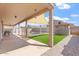 Inviting backyard with covered patio, artificial turf, and a view of the sparkling pool at 12745 W Calavar Rd, El Mirage, AZ 85335