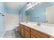 Bathroom with a double sink vanity, large mirror, and a combined tub and shower at 12745 W Calavar Rd, El Mirage, AZ 85335