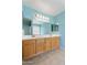 Well-lit bathroom with double sinks, large mirror, and stylish vanity at 12745 W Calavar Rd, El Mirage, AZ 85335