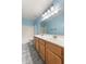 Bathroom featuring a double sink vanity, a large mirror, and a combined tub and shower at 12745 W Calavar Rd, El Mirage, AZ 85335