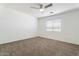 Bright bedroom featuring a ceiling fan and window, offering a serene and comfortable living space at 12745 W Calavar Rd, El Mirage, AZ 85335