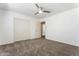 A carpeted bedroom featuring a closet and a doorway at 12745 W Calavar Rd, El Mirage, AZ 85335