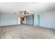 Spacious bedroom with plush carpeting and a ceiling fan, perfect for relaxation at 12745 W Calavar Rd, El Mirage, AZ 85335