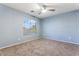 Carpeted bedroom with a ceiling fan and a window, providing a serene and comfortable atmosphere at 12745 W Calavar Rd, El Mirage, AZ 85335