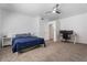 Bright bedroom with carpet flooring, ceiling fan, and neutral walls with office workspace at 12745 W Calavar Rd, El Mirage, AZ 85335