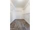 Organized walk-in closet offering plenty of shelving space for storage at 12745 W Calavar Rd, El Mirage, AZ 85335
