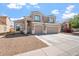 Charming two-story home featuring a three-car garage, neutral color palette and low maintenance front yard at 12745 W Calavar Rd, El Mirage, AZ 85335