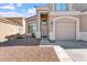 Charming home featuring a covered entry, neutral color palette, three-car garage and low maintenance front yard at 12745 W Calavar Rd, El Mirage, AZ 85335