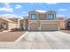 Impressive two-story home with a three-car garage and well-maintained landscaping at 12745 W Calavar Rd, El Mirage, AZ 85335