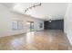 Spacious living area with a sliding glass door to the backyard, neutral walls, and tile flooring at 12745 W Calavar Rd, El Mirage, AZ 85335