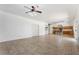 Open-concept living area features tile flooring, a ceiling fan, and easy access to the kitchen at 12745 W Calavar Rd, El Mirage, AZ 85335