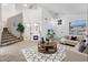 Bright living space with soaring ceilings, plush carpet, modern furniture and a charming fireplace at 12745 W Calavar Rd, El Mirage, AZ 85335