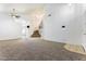 Open-concept living area features neutral paint, plush carpeting and a staircase leading to the second level at 12745 W Calavar Rd, El Mirage, AZ 85335