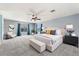 Large bedroom with a cozy seating area, large windows, soft carpet, and a neutral color palette at 12745 W Calavar Rd, El Mirage, AZ 85335