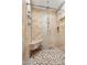 Luxurious shower with multiple shower heads, built-in bench, and stylish tile work at 12745 W Calavar Rd, El Mirage, AZ 85335