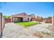 Backyard features artificial turf, desert landscaping, and covered patio for outdoor living at 12938 W Mandalay Ln, El Mirage, AZ 85335