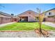 A well-maintained backyard with desert landscaping, artificial turf, and a covered patio at 12938 W Mandalay Ln, El Mirage, AZ 85335