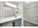 Well-appointed bathroom with modern vanity and a walk-in closet for extra storage at 12938 W Mandalay Ln, El Mirage, AZ 85335