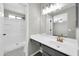 Bright bathroom featuring a walk-in shower, stylish vanity, and modern fixtures at 12938 W Mandalay Ln, El Mirage, AZ 85335