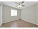 Clean bedroom with wood laminate floors, large window, and neutral walls at 12938 W Mandalay Ln, El Mirage, AZ 85335