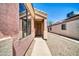 Home exterior showcases the front entrance, a security door, and low maintenance desert landscaping at 12938 W Mandalay Ln, El Mirage, AZ 85335