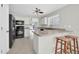 Spacious kitchen with white cabinets, stainless appliances, and a convenient breakfast bar at 12938 W Mandalay Ln, El Mirage, AZ 85335
