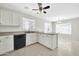 Well-lit kitchen featuring white cabinets, neutral countertops, a modern faucet, and black appliances at 12938 W Mandalay Ln, El Mirage, AZ 85335